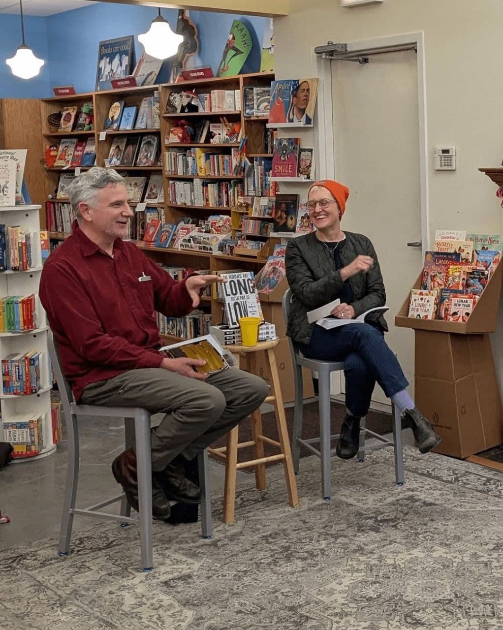 Two authors sharing a laugh during an intimate bookstore conversation event